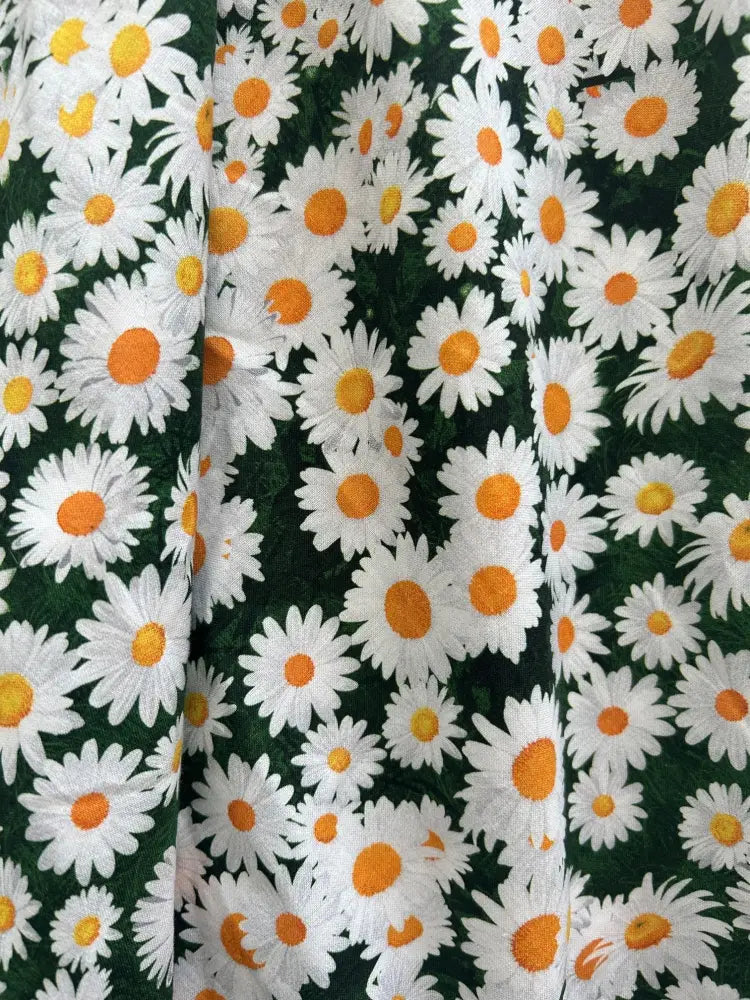 Retro Licious Greta 1950s cotton dress with vibrant green fabric and white daisies with bright orange centers