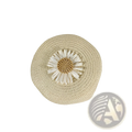 Beige woven straw crossbody bag adorned with a white daisy embellishment round shoulder purse