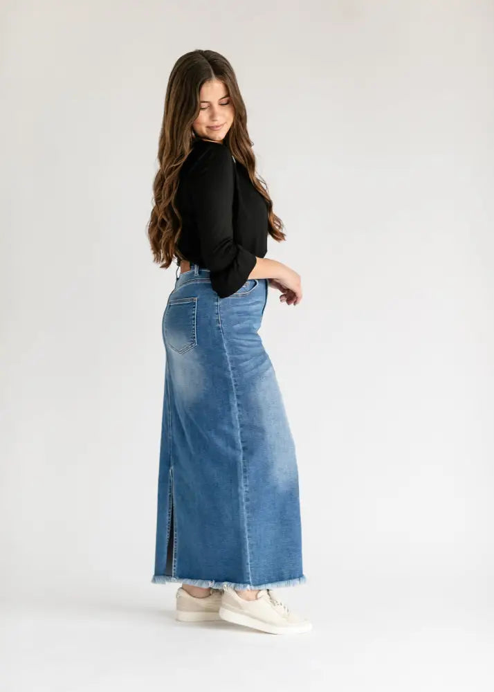 Dakotah raw hem high waisted denim maxi skirt in medium-wash with front slit and frayed hem detail