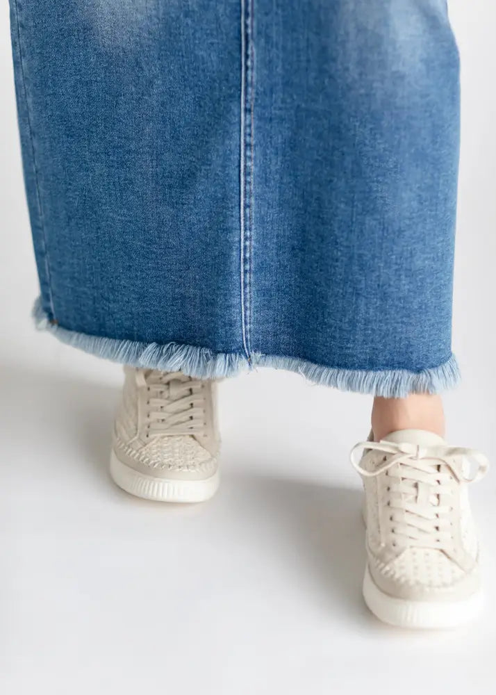Beige woven uppers with white rubber soles and laces paired with dakotah raw hem high waisted denim maxi skirt