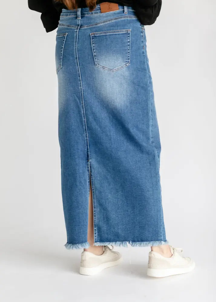 Dakotah raw hem high waisted denim maxi skirt in mid-blue with front slit and frayed hem detail