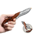 Damascus steel folding kitchen knife with wooden handle and intricate wave patterns in leather bag