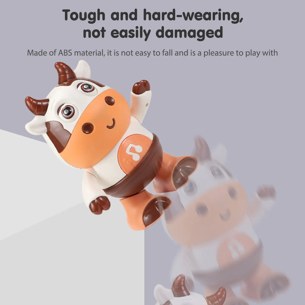 A cheerful orange and white plastic dancing cow musical robot toy with brown horns eyes and hooves