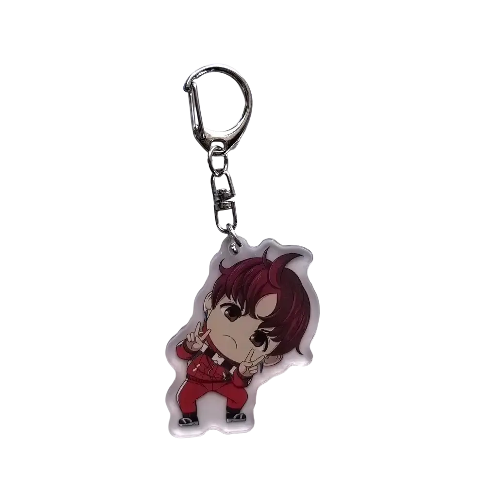 Clear acrylic dandadan anime keychain featuring a chibi momo character with maroon hair and red outfit attached to silver clasp