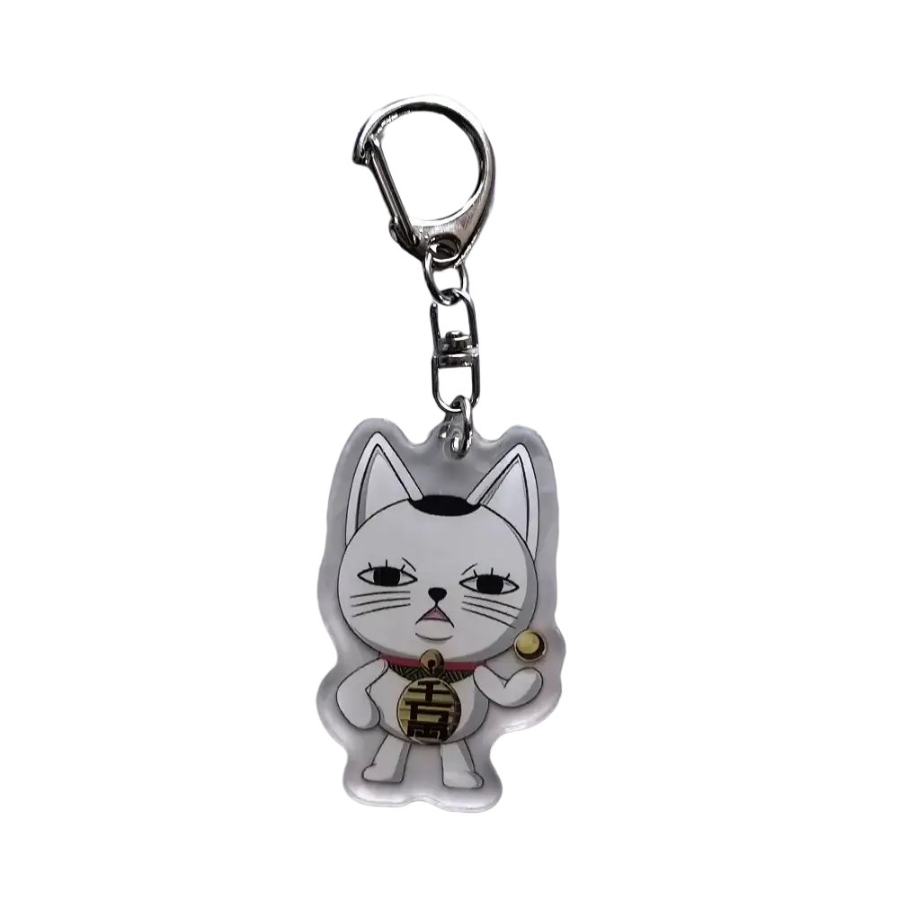 Clear acrylic keychain featuring a white cartoon cat with black ears holding a golden coin in dandadan anime style