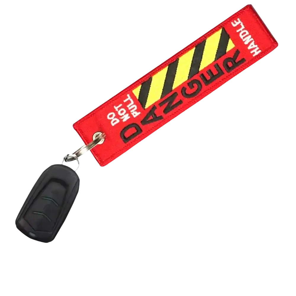 Red embroidered aviation warning tag keychain with black and yellow stripes and handle with care text for jdm motorcycle use