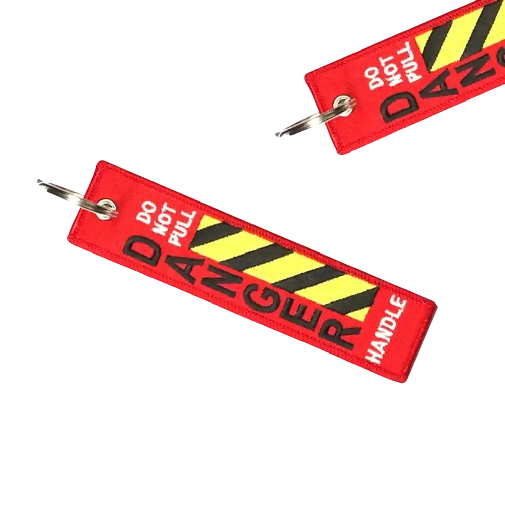 Red embroidered aviation warning keychain with bold black danger lettering and yellow black striped hazard pattern for jdm motorcycle use