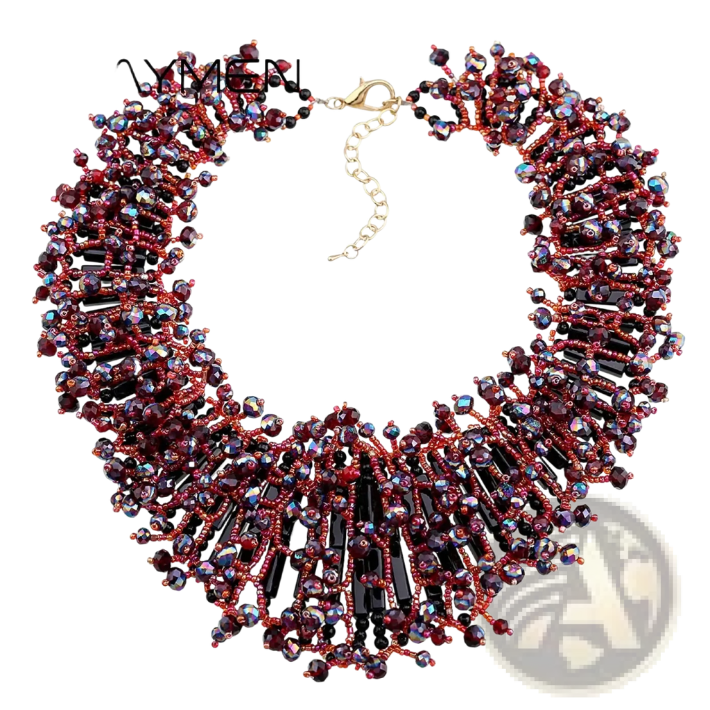 A dark blue crystal statement necklace by Kaymen featuring intricate beading with deep red and black faceted crystals