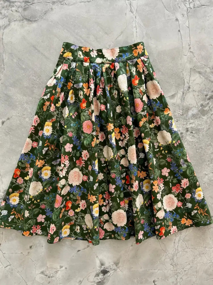 Dark floral doris high waisted cotton midi skirt with pockets featuring a flared design and vibrant floral pattern on dark green
