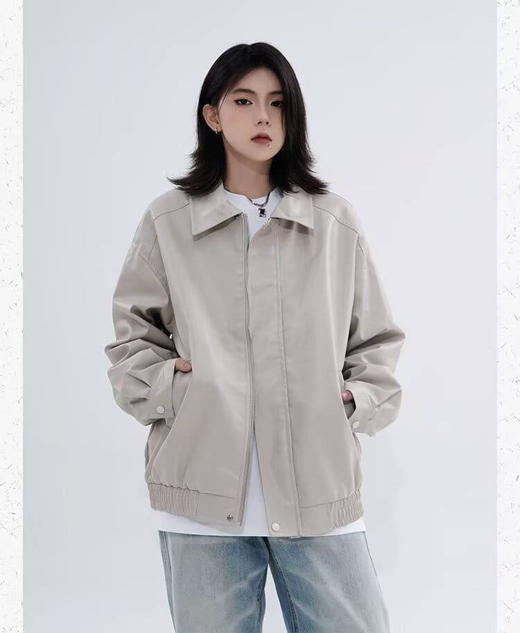 Men’s beige faux leather bomber jacket with relaxed fit featuring a front zipper closure and ribbed cuffs.