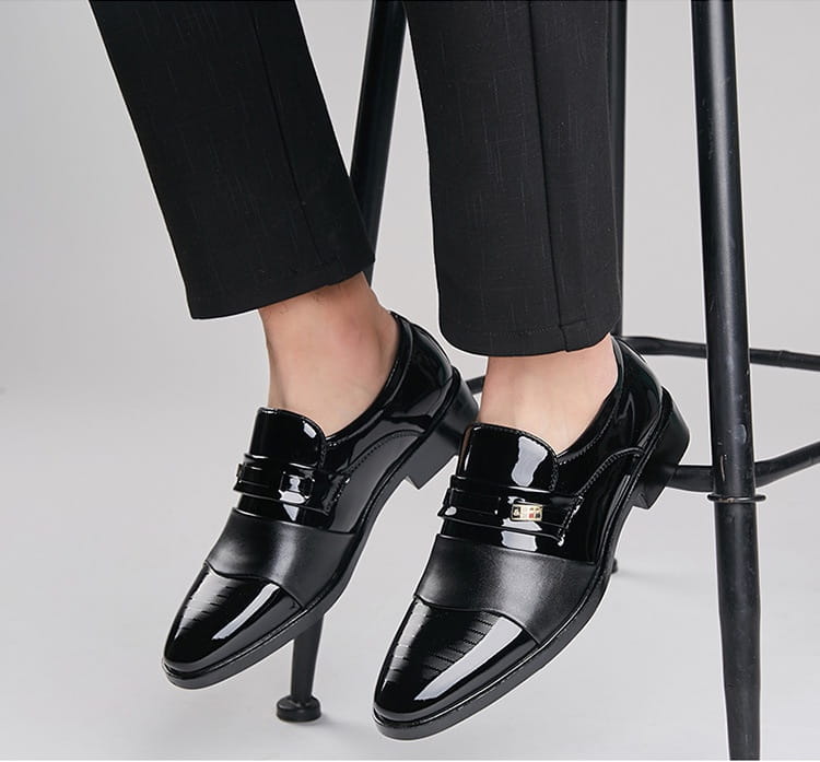 Men’s black patent leather lace-up dress shoes with glossy finish and gold-tone buckle for business and formal wear