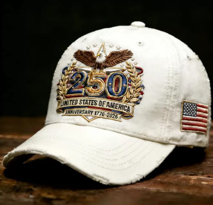 White distressed baseball cap featuring an embroidered eagle with gold and blue 250 and laurel wreaths and a banner reading United States of America anniversary 1776-2026 for usa 250th anniversary celebration.