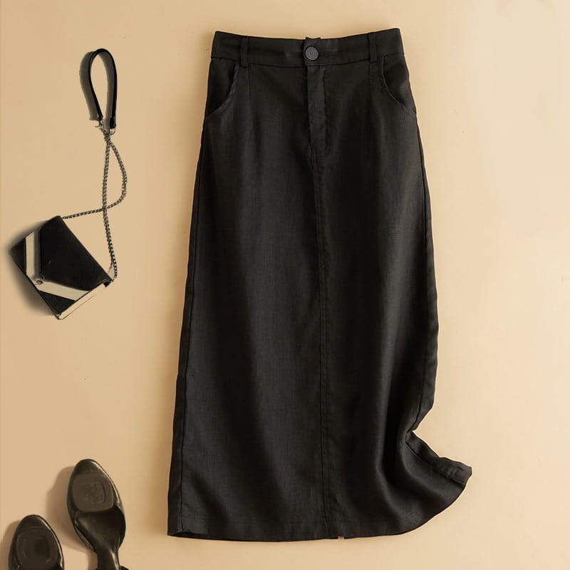 Falda midi vintage de algodón y lino de cintura alta en color negro con una silueta recta y elegante, y un sutil detalle de costura en la parte delantera.
