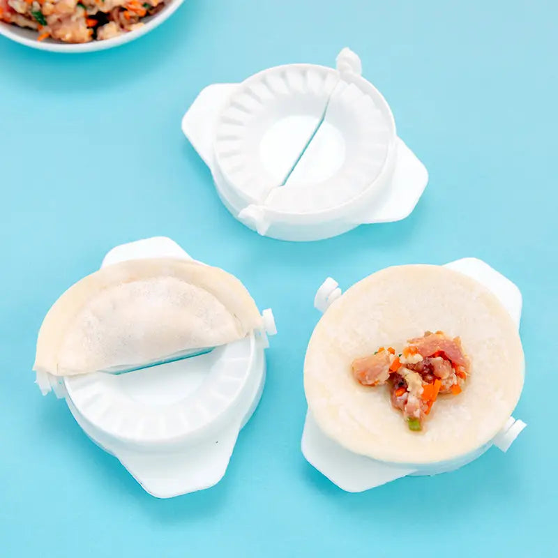 White plastic dumpling maker 3 in 1 manual dough pressing tool with fluted edges and a central slit for sealing.