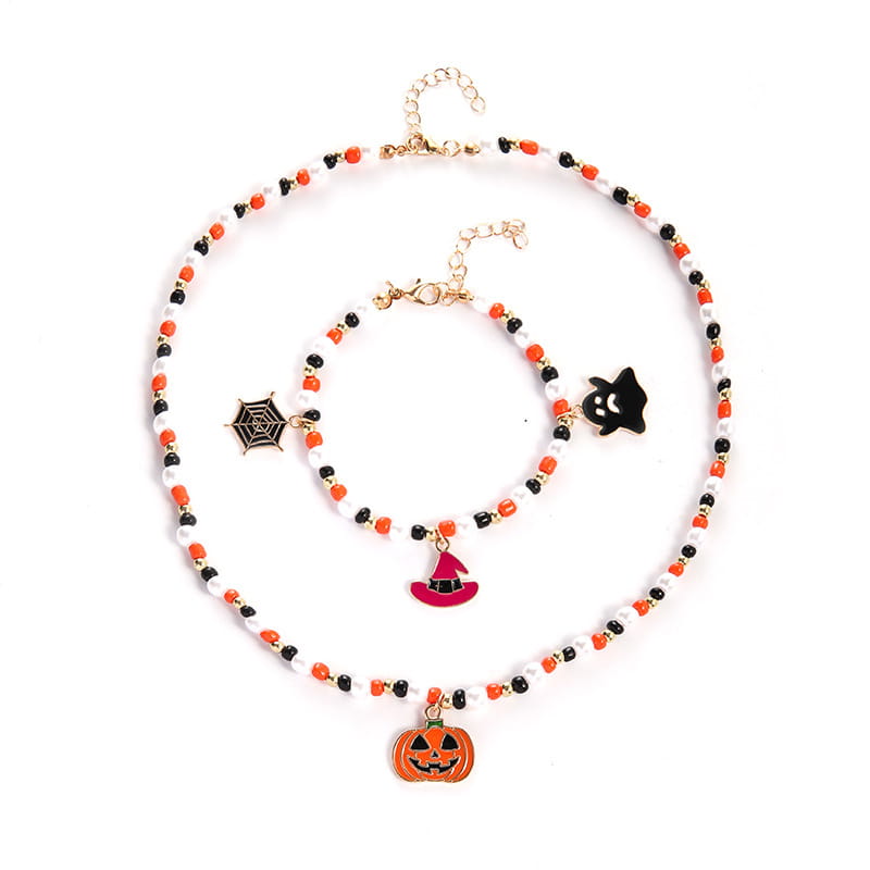Halloween ghost and pumpkin beaded jewelry set featuring an orange black and white beaded necklace with dangling pumpkin witch hat spiderweb and ghost charms.