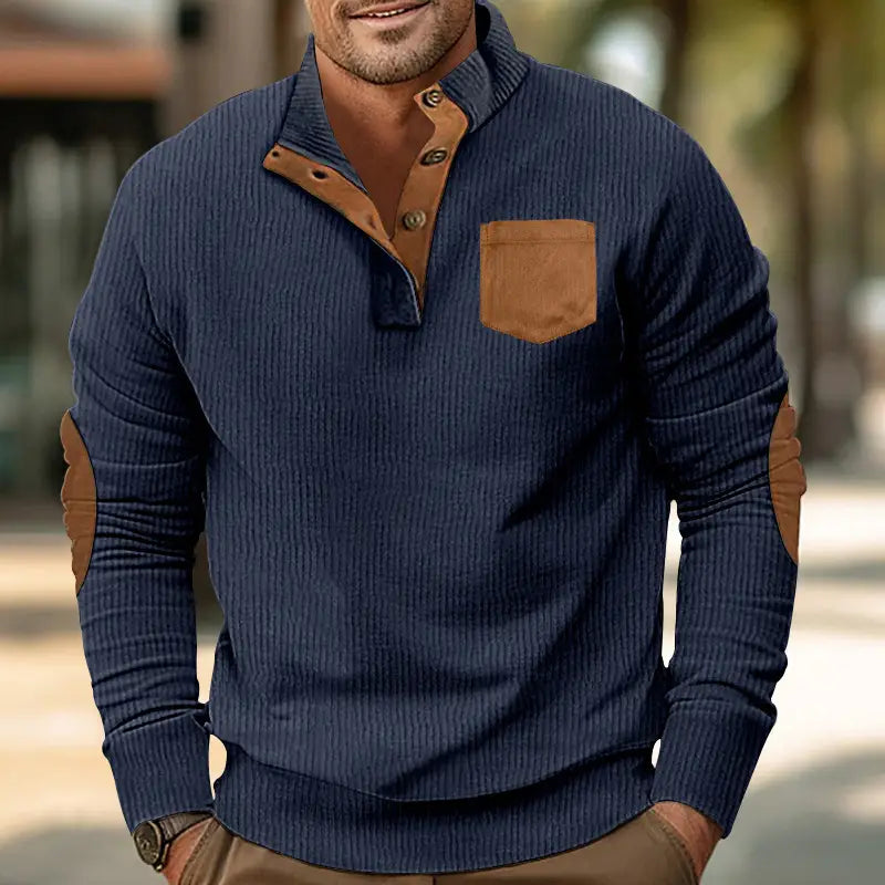 Navy blue slim fit ribbed knit sweater with brown leather-like corduroy patchwork accents on collar chest pocket and elbows.