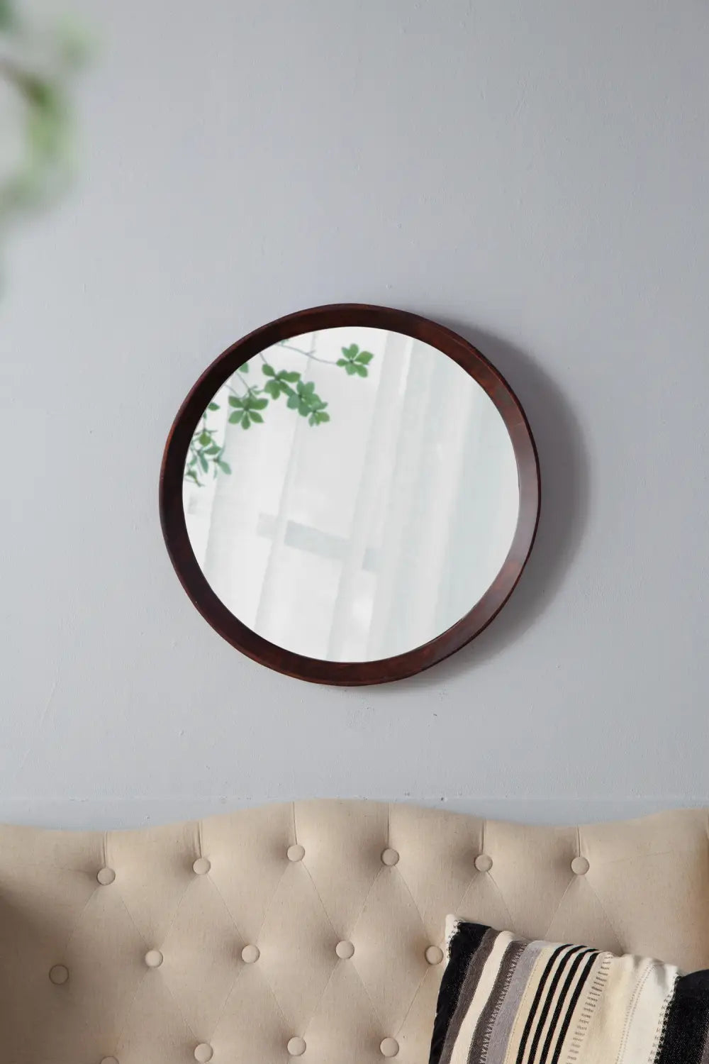 Round wooden-framed wall mirror with a 20 inch mango wood frame and dark bronze finish for home decor.
