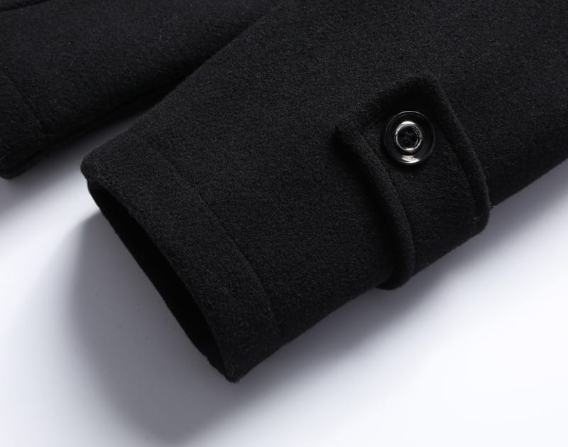 black woolen coat cuff with a sleek black button on a men wool winter overcoat quilted jacket