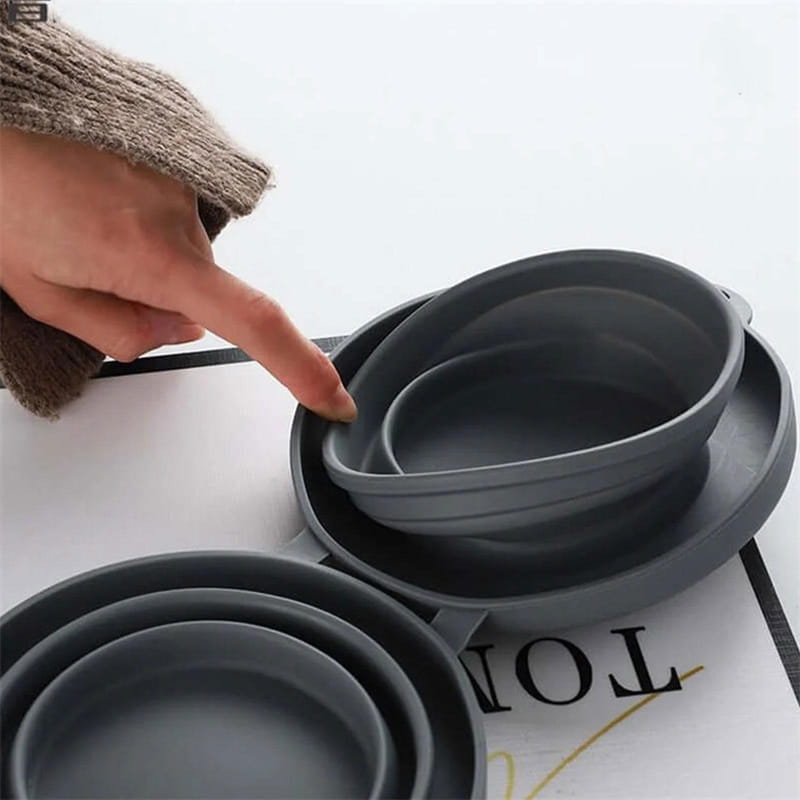 Set of collapsible gray silicone dog bowls in nested sizes for travel use in a double silicone travel set.