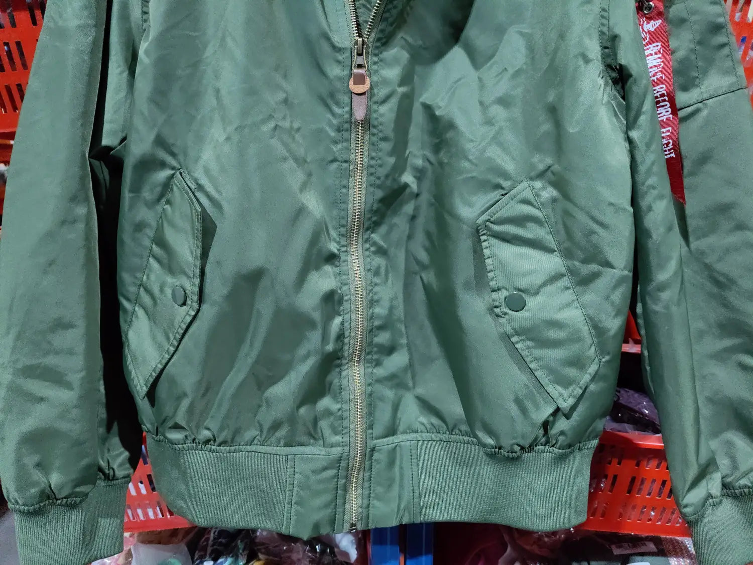 Olive green ma1 pilot bomber jacket with central zipper ribbed cuffs and waistband and two slanted pockets for casual wear.