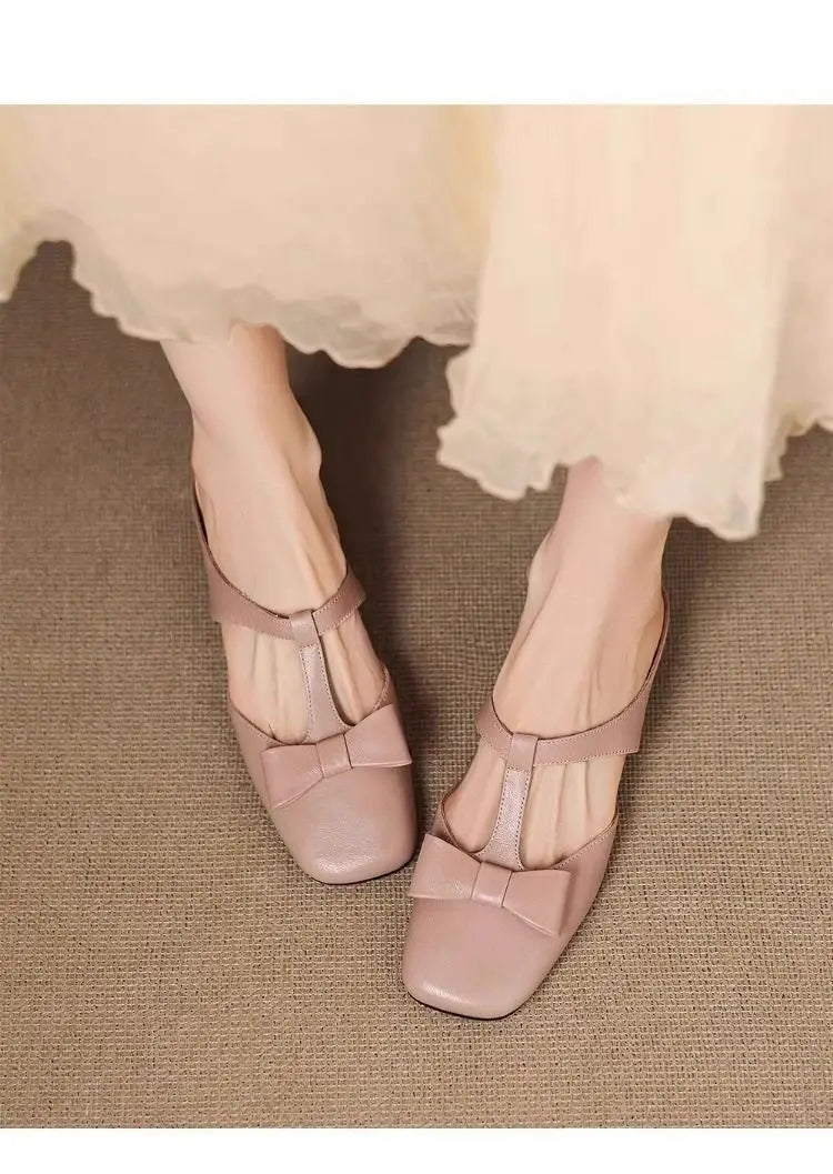 Beige leather bow closed toe mule flats for women featuring square toe and t-strap design.