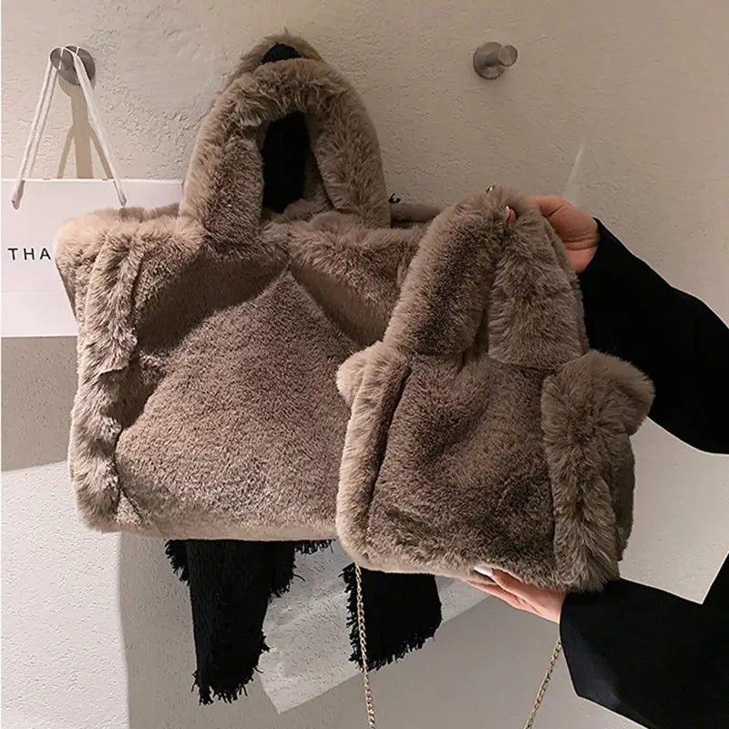 Plush faux fur tote bag with chain strap shoulder bag featuring a soft fluffy texture and matching handles in a neutral color.