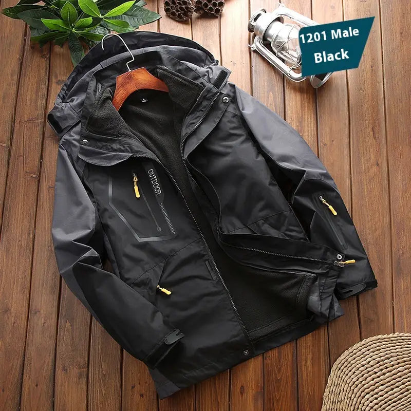Men three-in-one waterproof winter sportswear jacket in black with yellow zipper pulls and a hood displayed on a wooden hanger.