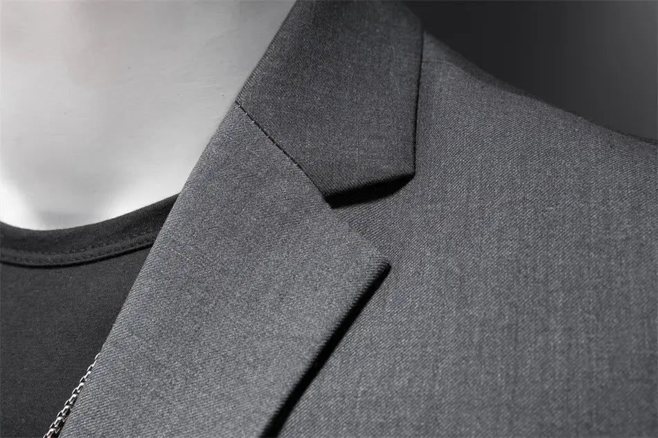 Chaqueta de vestir empresarial de pana gris oscuro con ajuste slim, confeccionada en lana texturizada, con cuello estructurado.