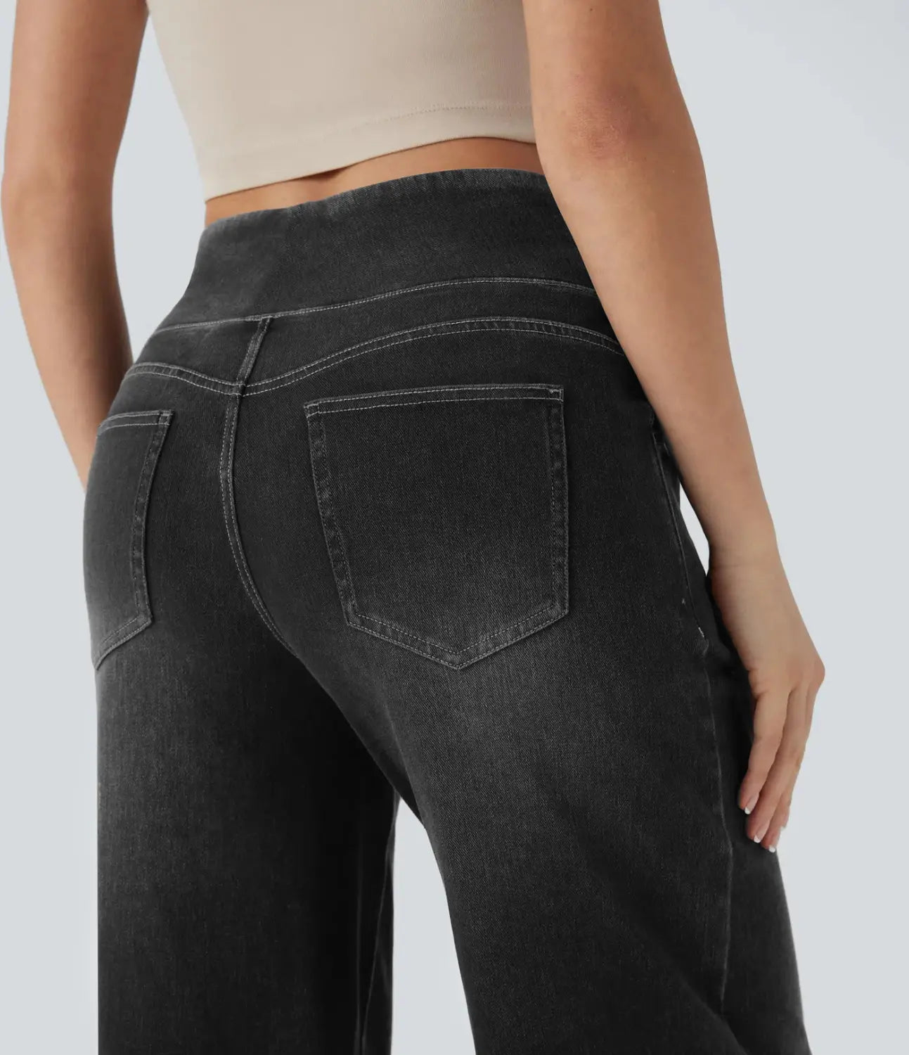 Wide leg stretchy high waisted black denim jeans with a relaxed fit and subtle fading