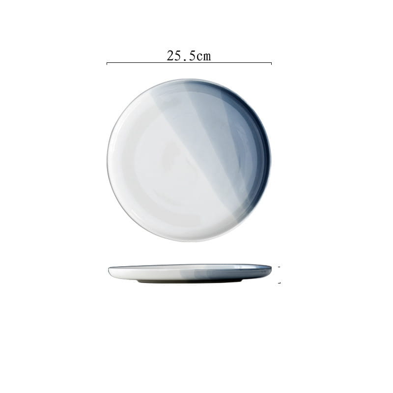 A 25.5cm diameter ceramic steak plate with a smooth glossy finish and a subtle gradient from white to soft blue-gray in the ceramic gradient blue steak plate and bowl set.