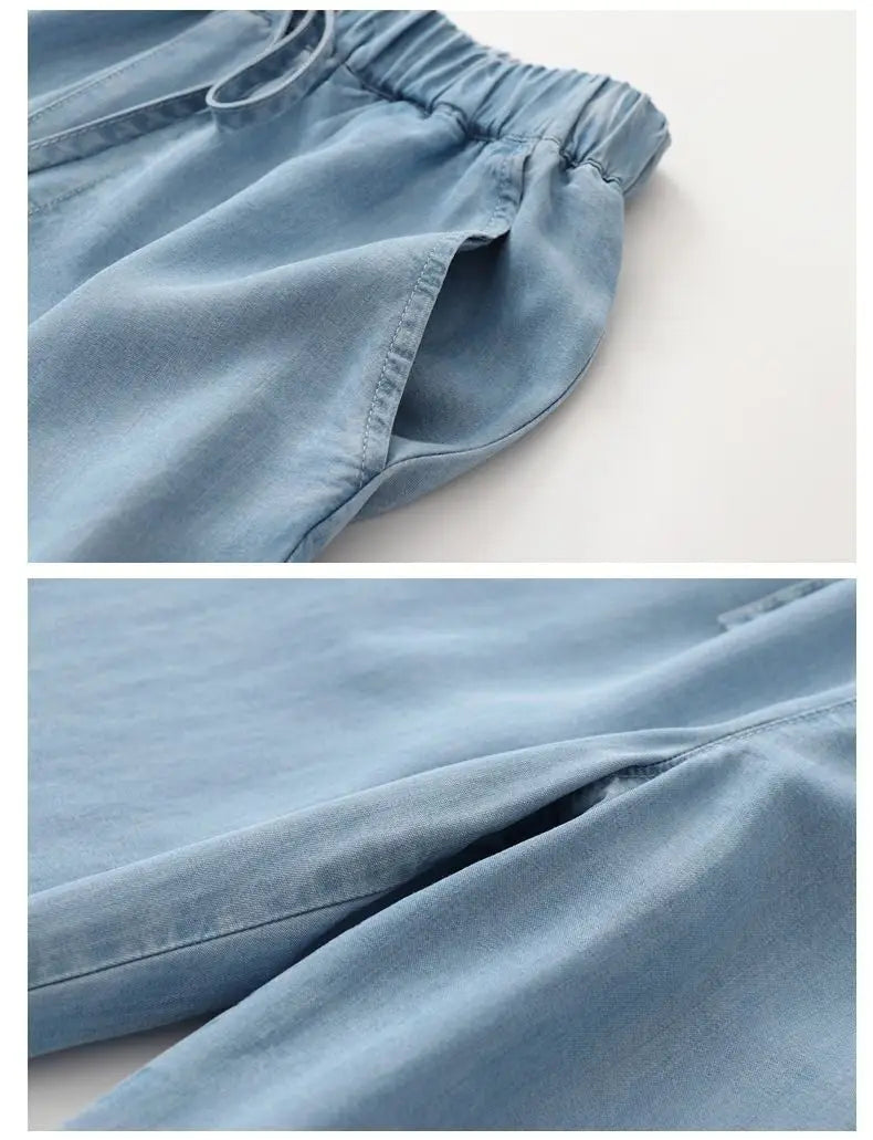 Light blue high waisted harem jeans made of denim featuring an elastic waistband and side pockets.