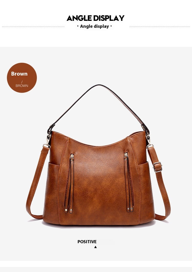 brown leather hobo bag with tassel, two front zippered pockets, and a detachable shoulder strap.