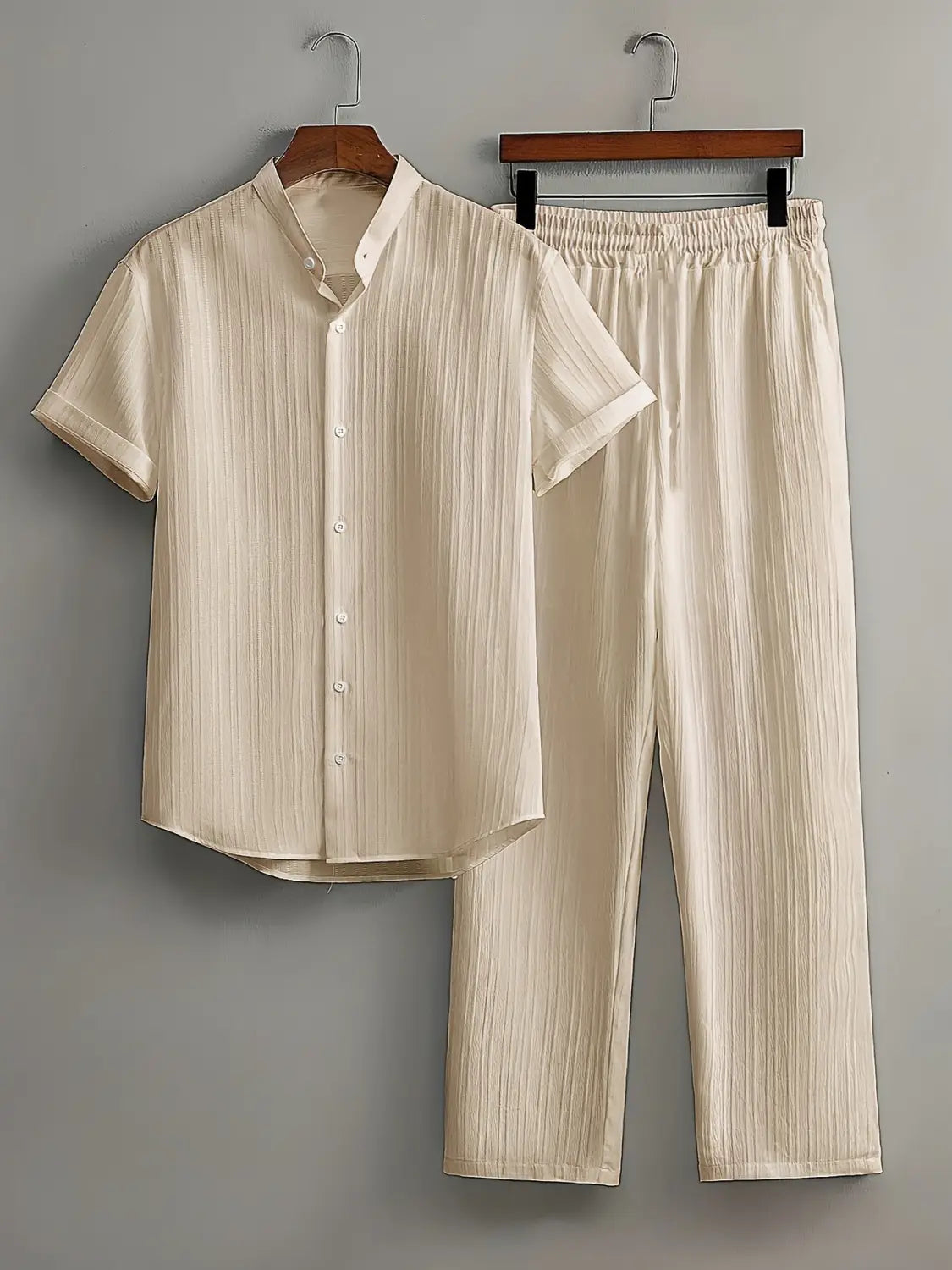 Mens pleated short sleeve shirt and pants set in cream color with vertical ribbed texture and short sleeves.