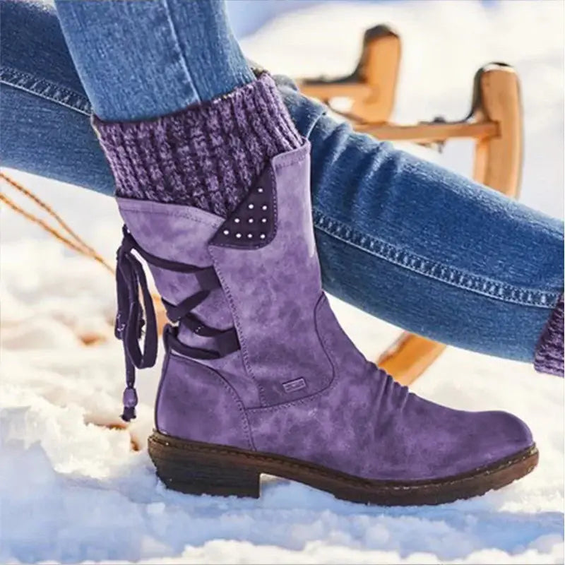 Purple suede mid calf women winter snow boot with black lace-up detailing and decorative silver stud patch on the side.