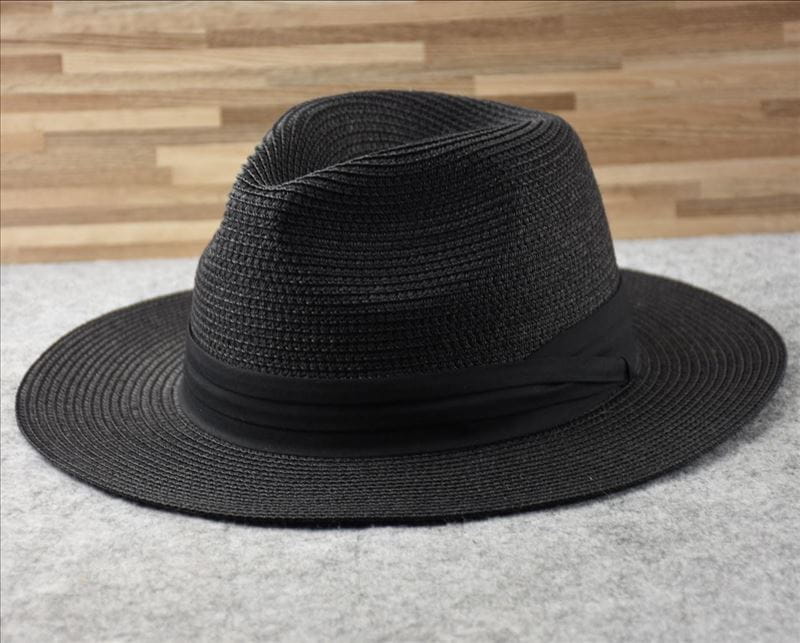 Black woven straw fedora hat with a smooth black ribbon band designed for foldable sun protection for men.