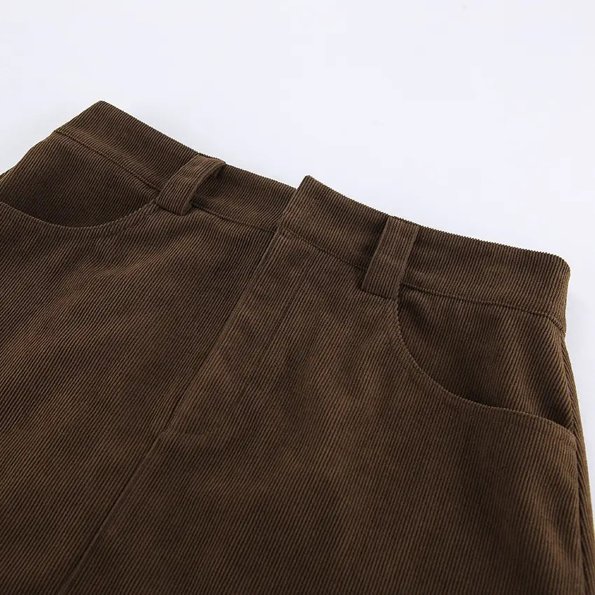 Brown corduroy mini skirt with a high waist front pockets and matching belt in a retro style.