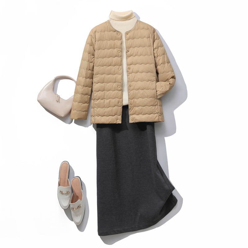 Beige quilted puffer jacket with a rounded collar and button closure featured in the Puff Jacket Ruffled Crew Neck collection.