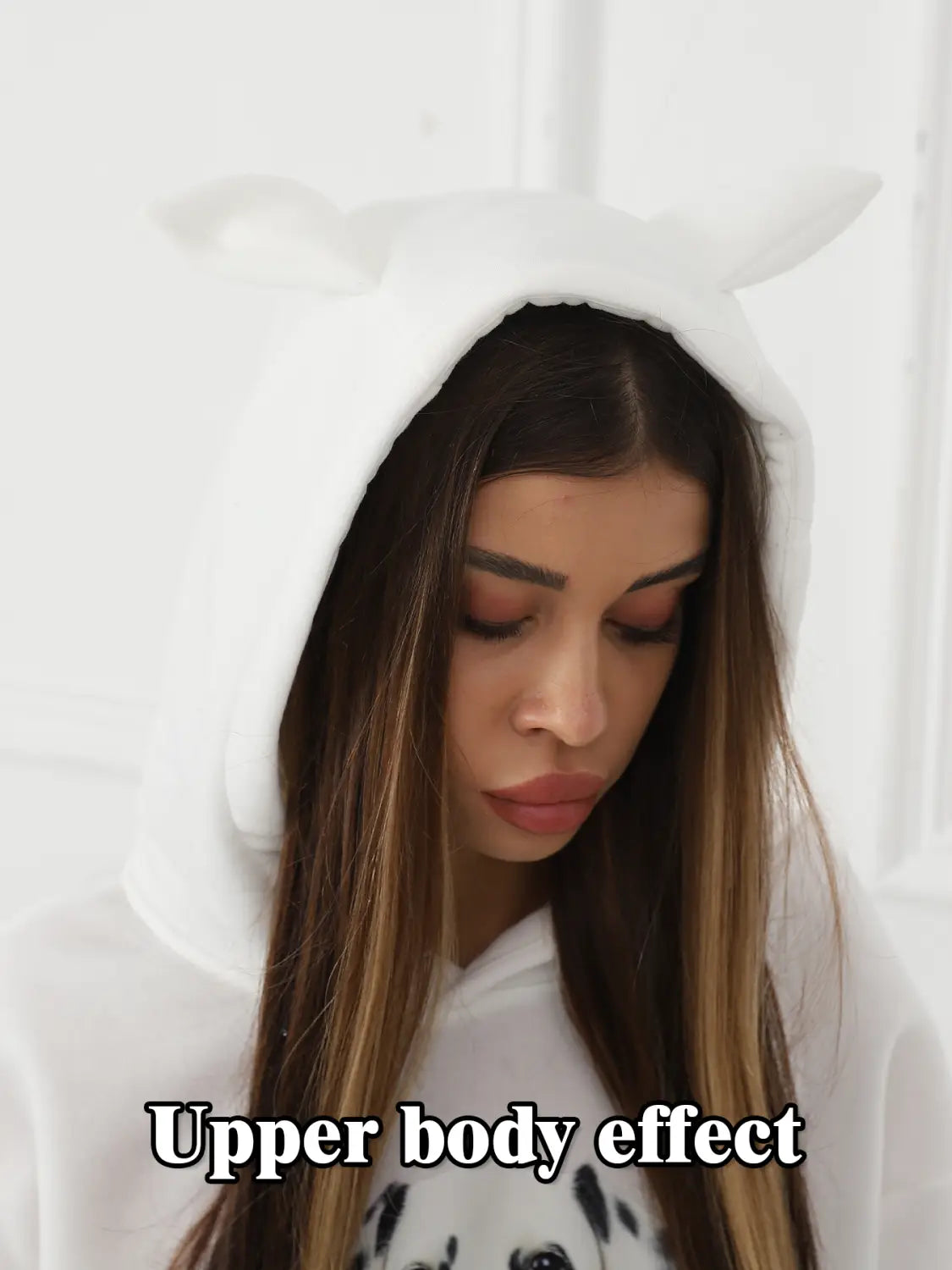 White hooded onesie in dalmatian print featuring soft plush material and attached cat ear hood designed for women