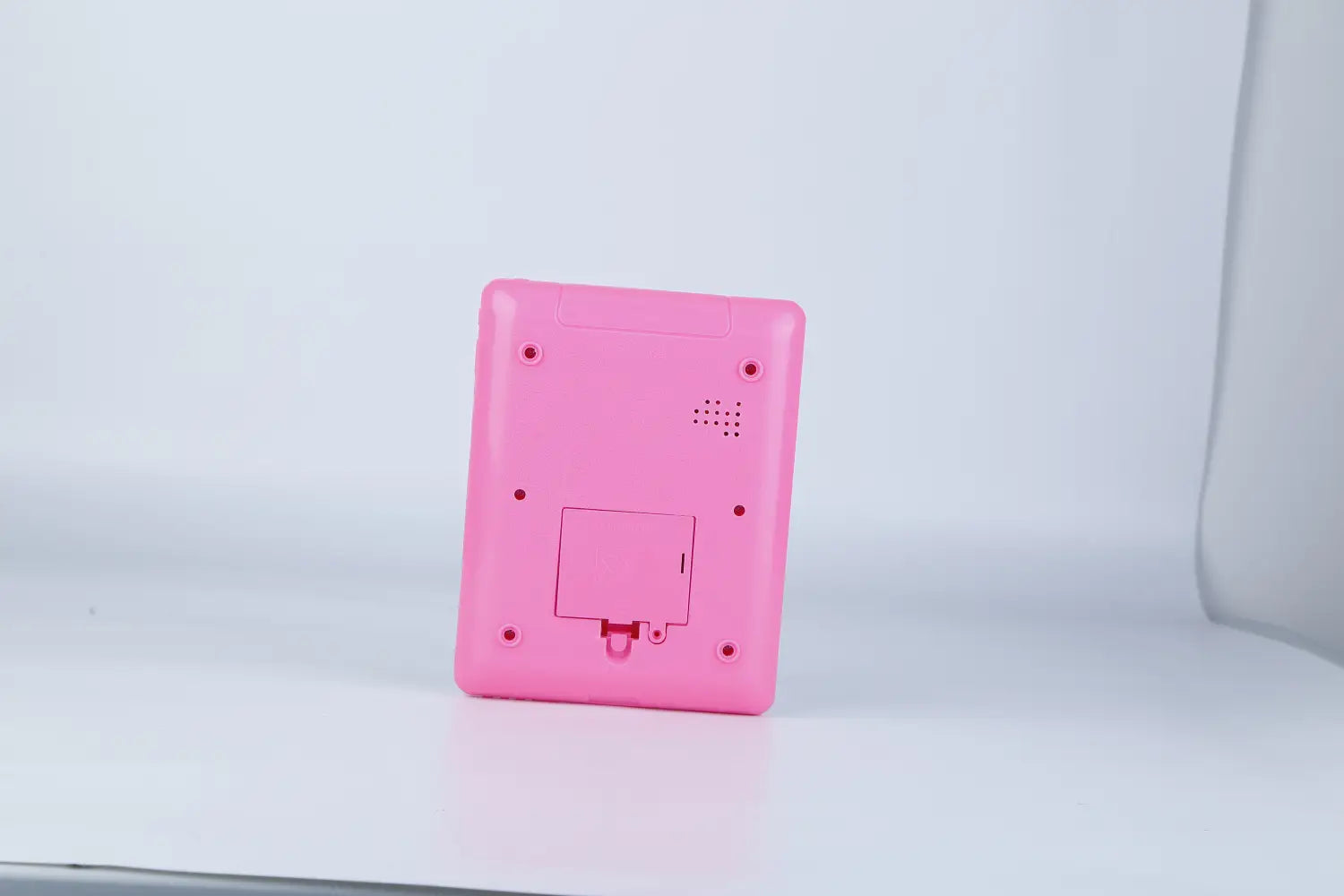A pink plastic handheld baby learning tablet educational toy for toddlers with a rectangular shape and rounded corners.
