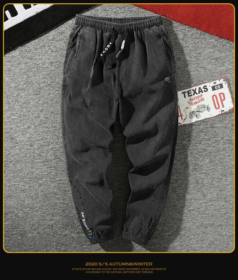 men’s relaxed fit black denim joggers with elastic waistband and drawstring featuring subtle branding on the side pockets