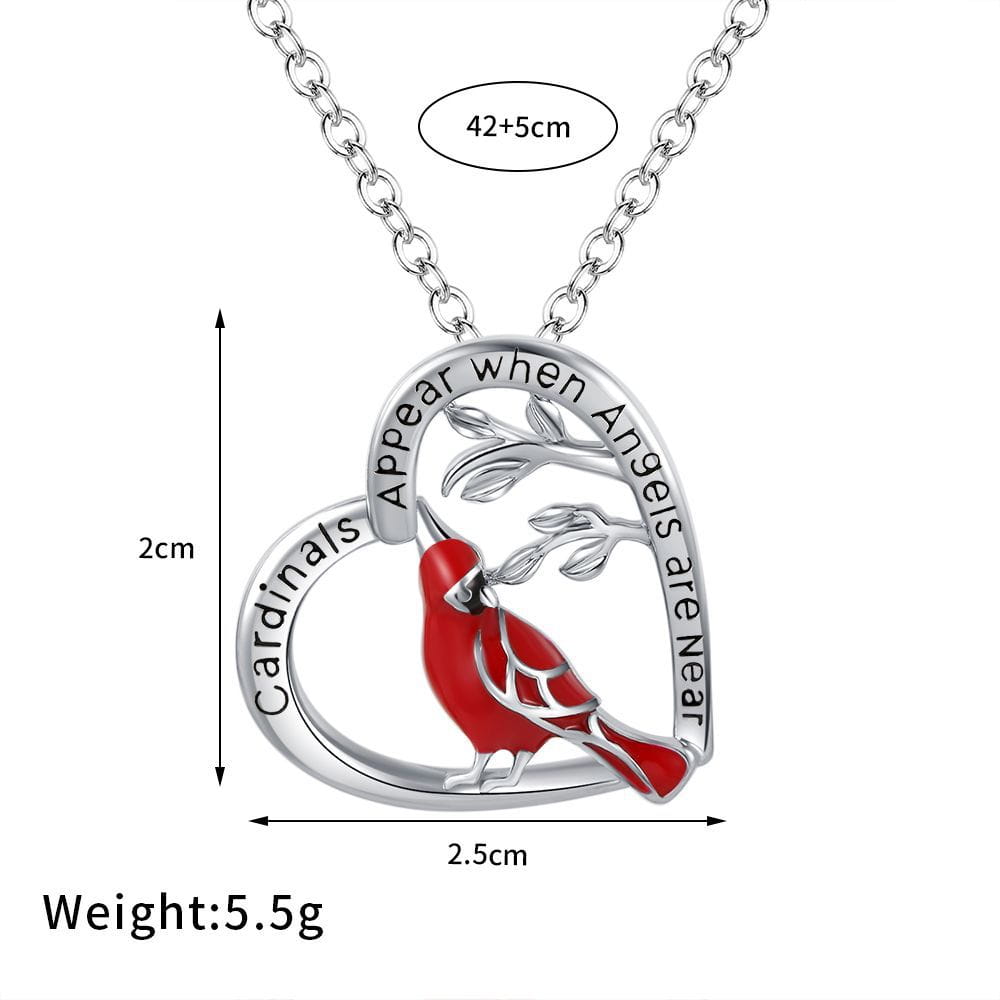 a silver heart-shaped pendant necklace featuring a red cardinal and intricate branch details engraved with cardinals appear when angels are near