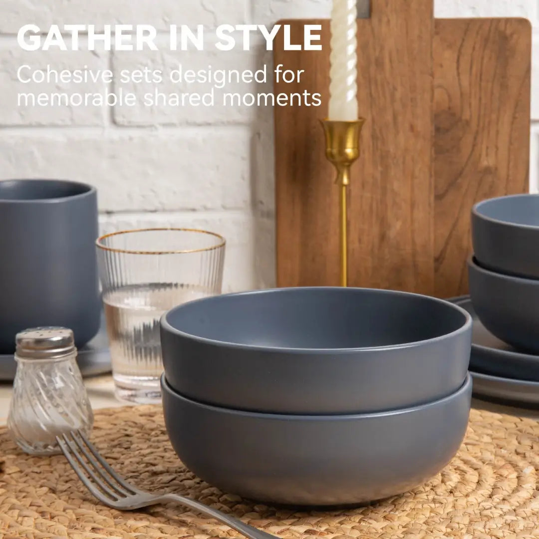 Stacked matte gray ceramic bowls with a modern minimalist design from a 12-piece stoneware dinnerware set matte glaze service for 3.