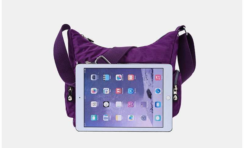 Waterproof purple nylon crossbody shoulder bag with zippered compartments and adjustable strap.