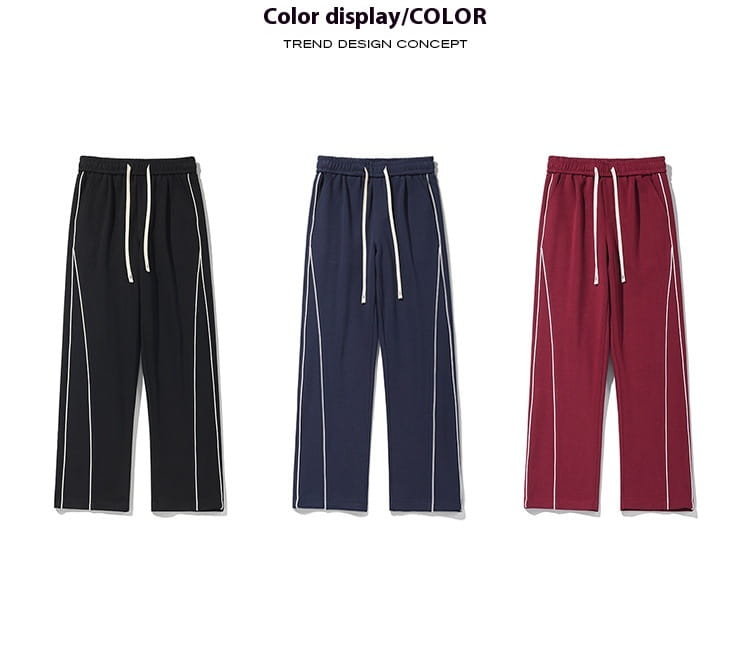 Wide leg striped track pants shown in black navy blue and maroon featuring white side stripes and matching drawstrings in a comfortable fabric.