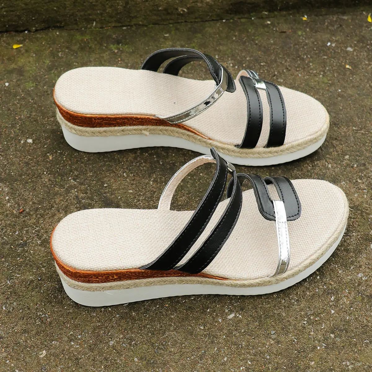 black and silver strap espadrille wedge sandals with woven jute sole and metal accents shown from the back side