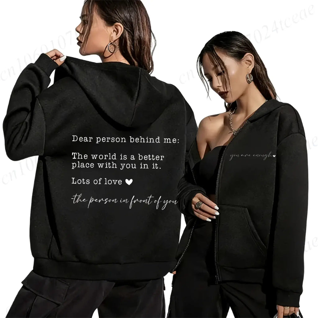 Black zip up hoodie showing the back with a sentimental message printed in white cursive script titled dear person behind me