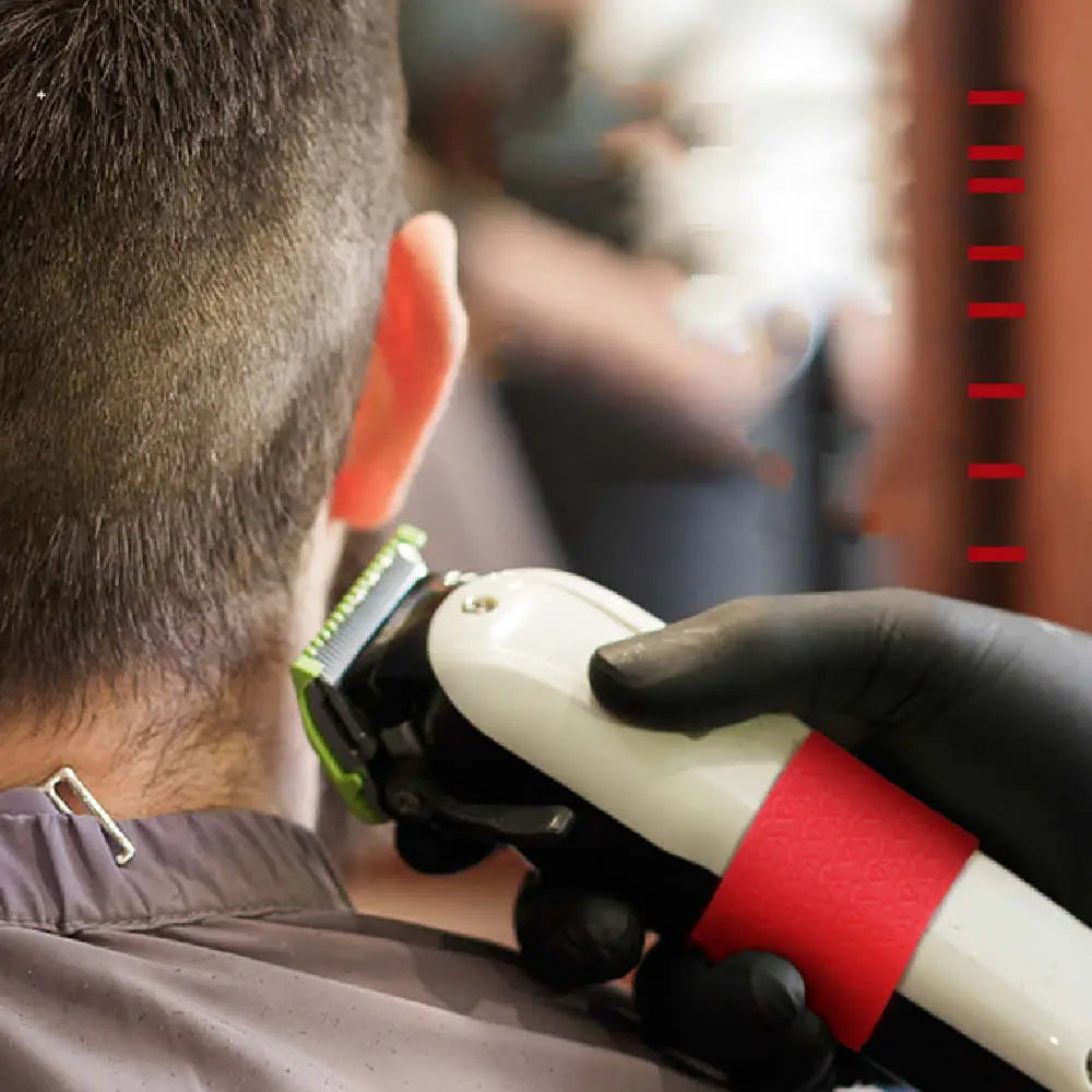 white and green electric hair clipper featuring an anti-slip red silicone grip ring designed for secure handling during grooming.