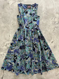 A sleeveless a-line vintage paisley deco floral midi dress with pockets in blue green and black shades