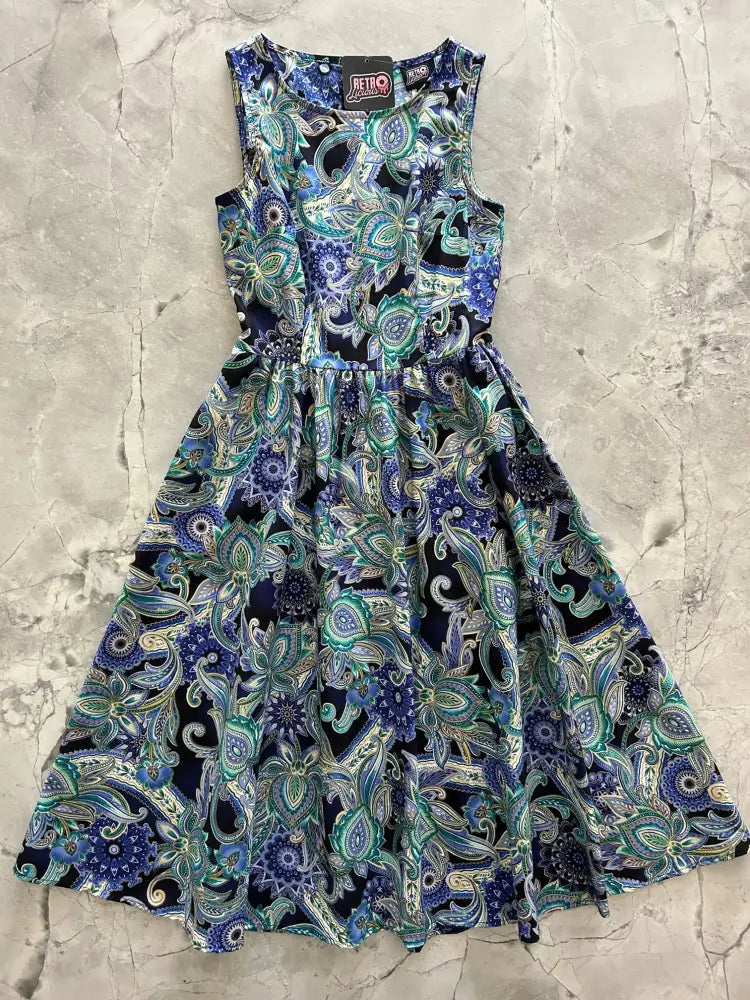 A sleeveless a-line vintage paisley deco floral midi dress with pockets in blue green and black shades