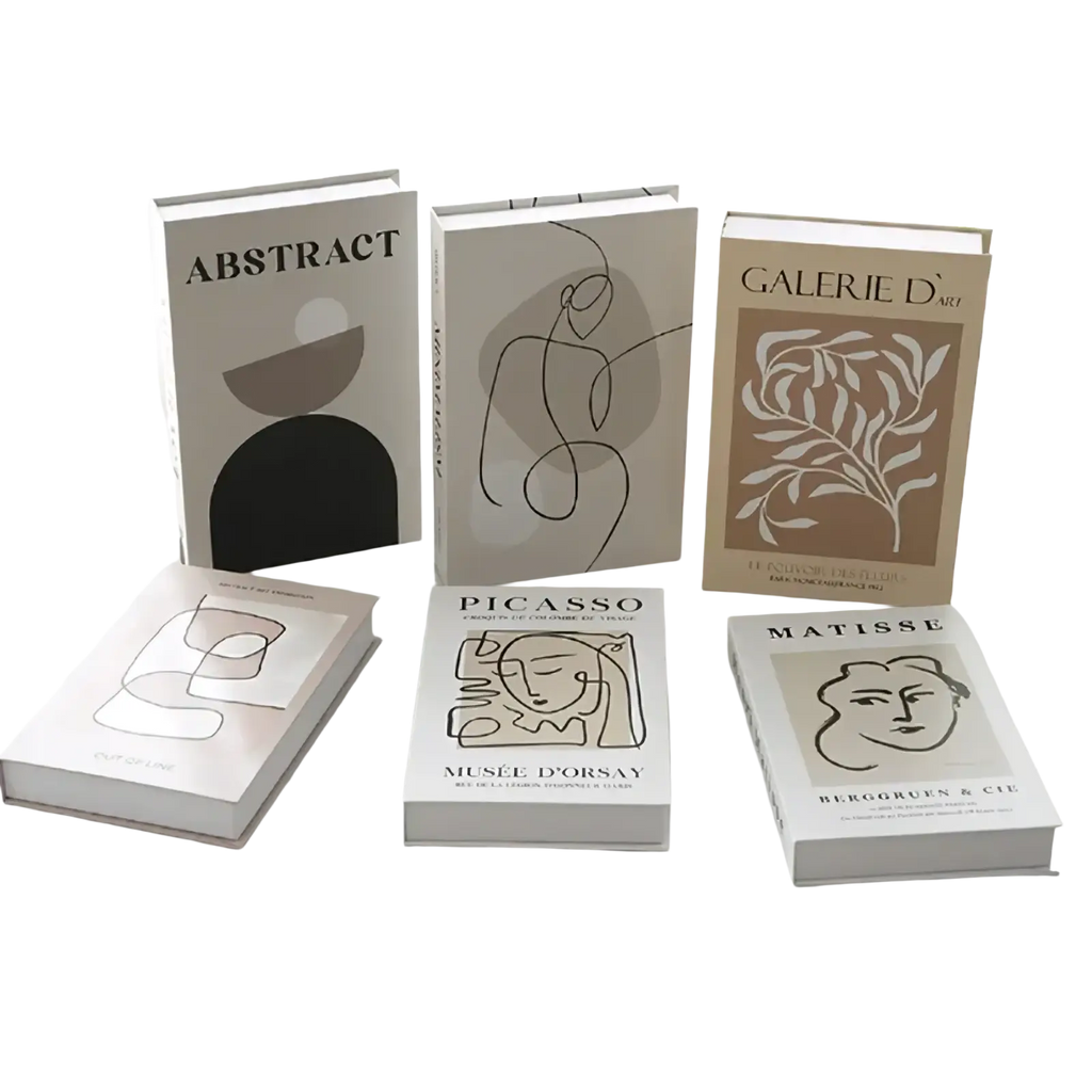 Set of six minimalist art-themed decorative fake books in neutral tones with abstract line-art for coffee table decor